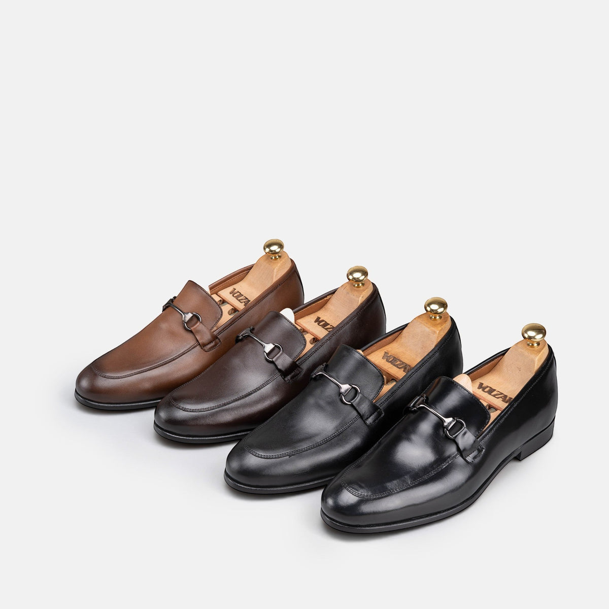 VOLZAK leather loafers in black and brown shades featuring metal horsebit hardware and wooden shoe trees